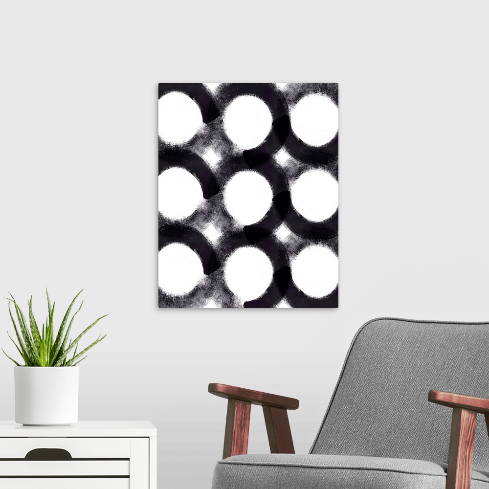 A modern room featuring A vertical painting of circles with black brush strokes.