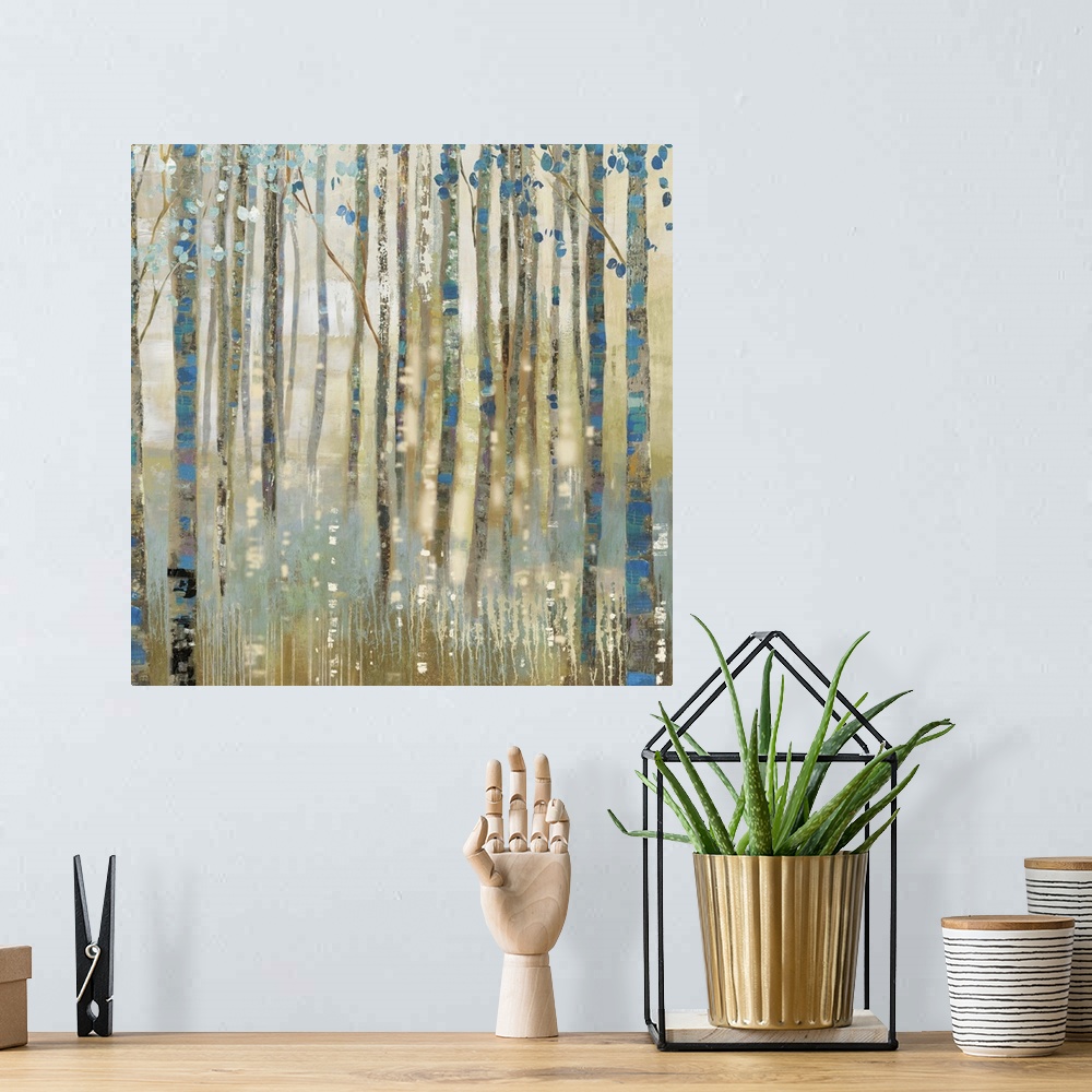 A bohemian room featuring Contemporary home decor artwork of a golden forest with blue accented trees.