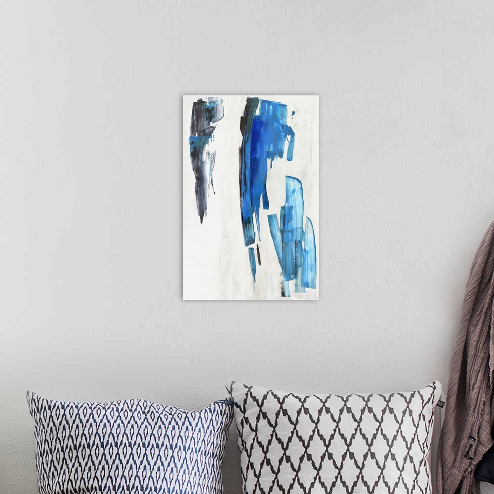 A bohemian room featuring An abstract painting of shapes in a vibrant color of blue.