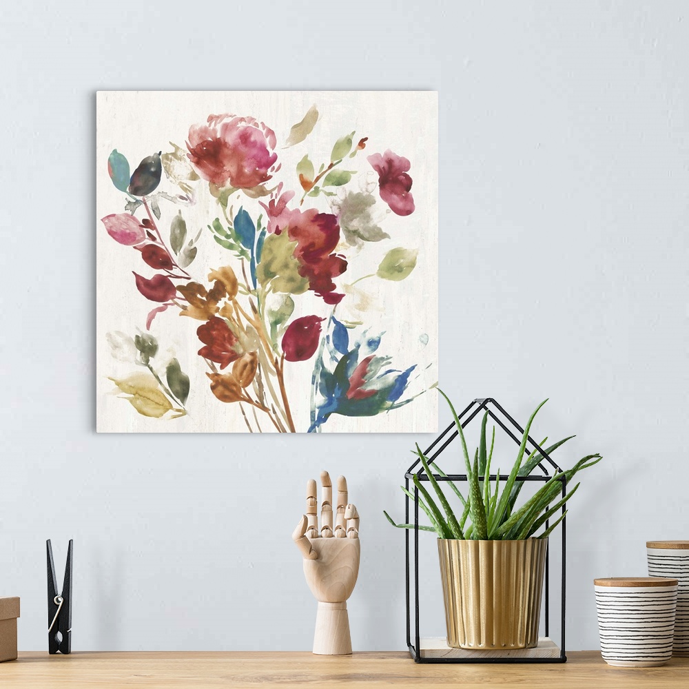 A bohemian room featuring Watercolor artwork of pink, green, and blue flowers over a cream colored background.