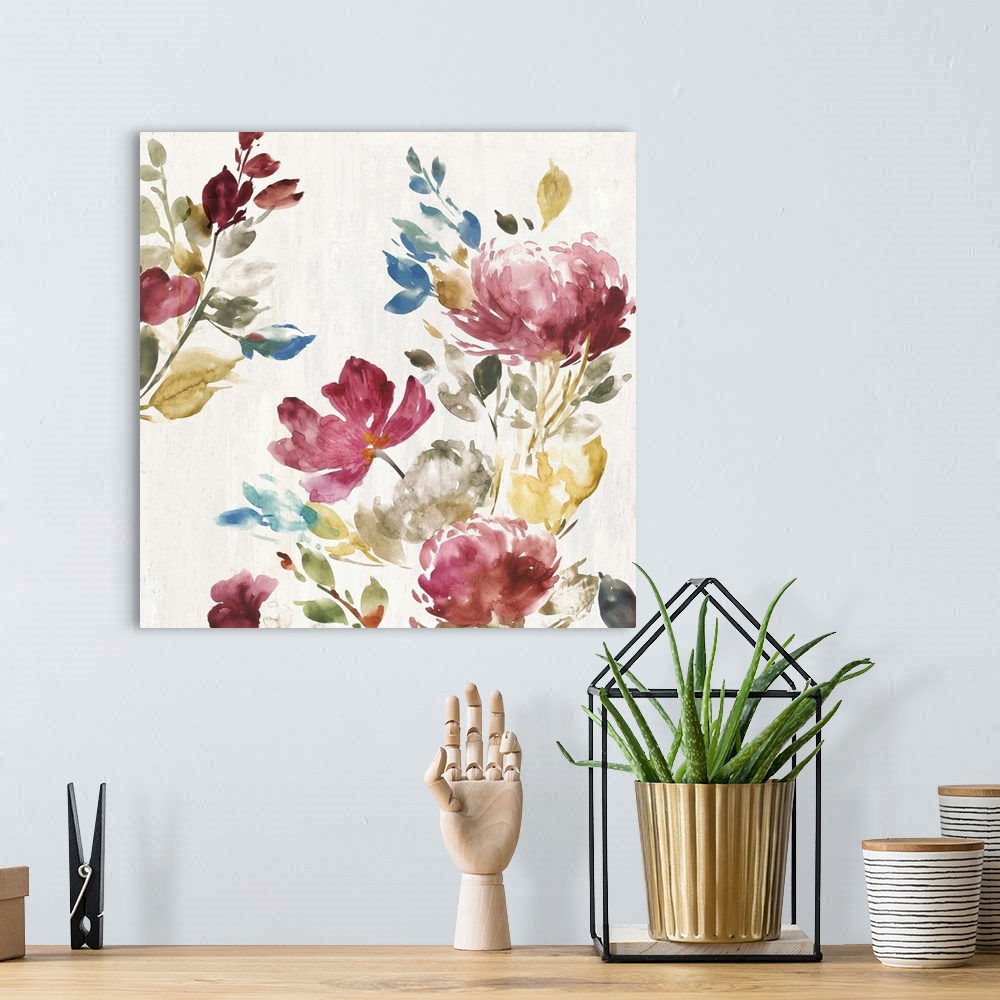 A bohemian room featuring Watercolor artwork of pink, green, and blue flowers over a cream colored background.
