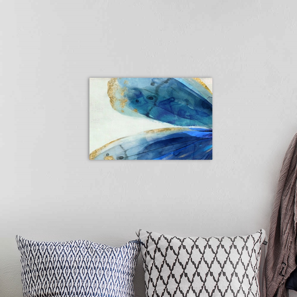 A bohemian room featuring Abstract artwork of large blue areas edged with gold.