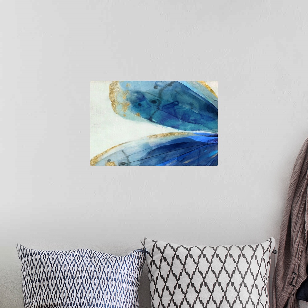 A bohemian room featuring Abstract artwork of large blue areas edged with gold.
