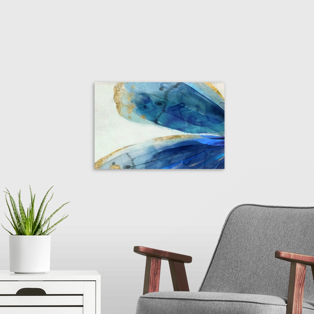 A modern room featuring Abstract artwork of large blue areas edged with gold.