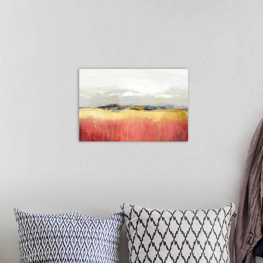 A bohemian room featuring Landscape painting of a yellow field under an overcast sky.