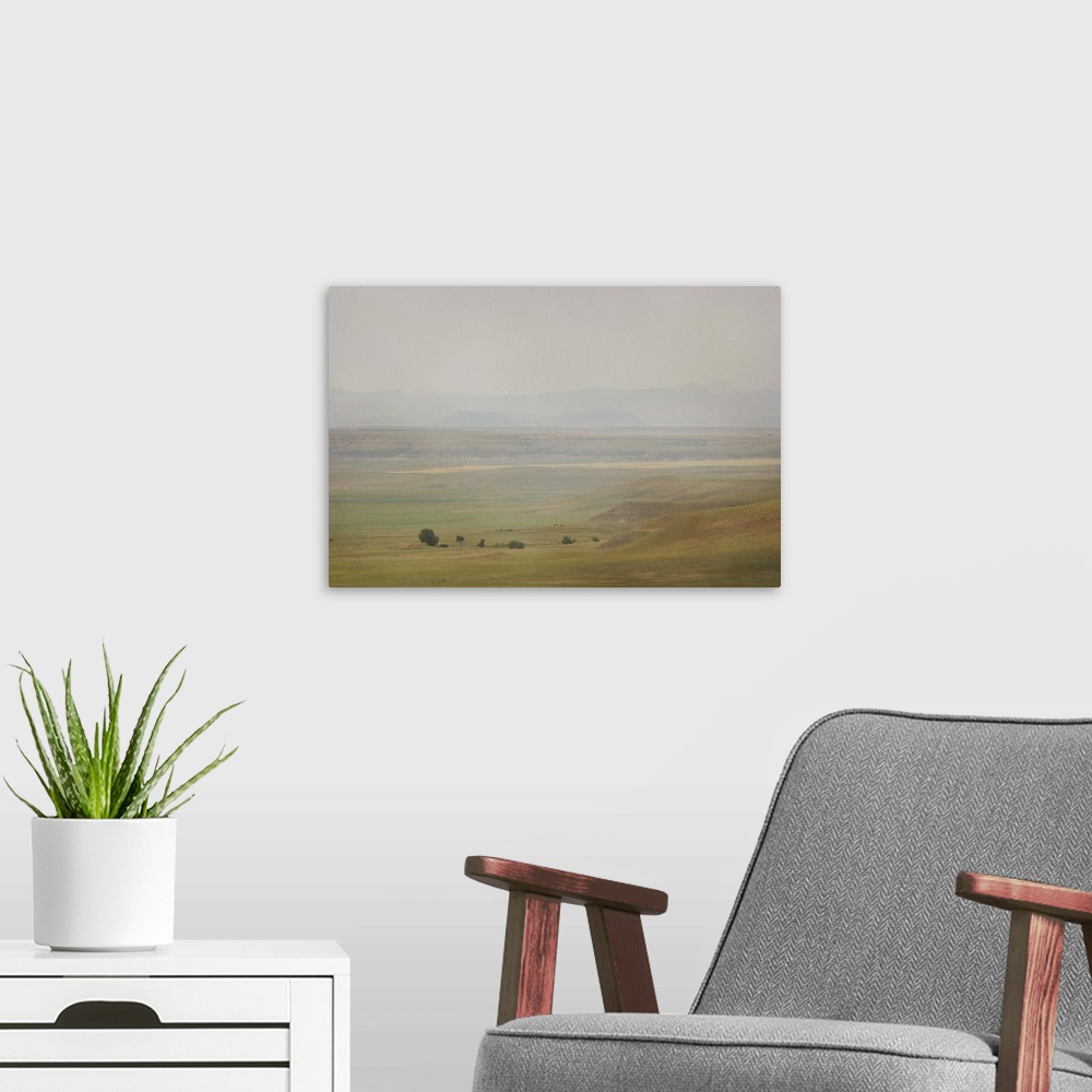 A modern room featuring A pictorialist landscape photograph of a western prairie landscape of Montana, USA. Farms up agai...