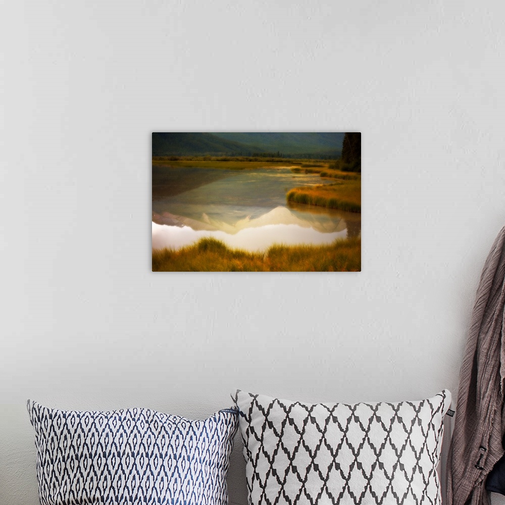A bohemian room featuring A photograph of a mountain reflection in a lake with a distressed overlay to the photo.