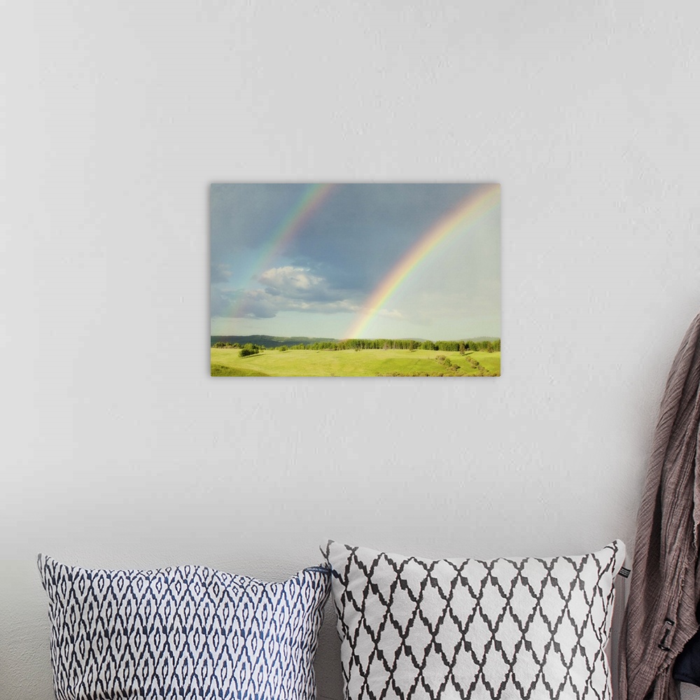 A bohemian room featuring Photograph of a lush green landscape with a double rainbow overhead.
