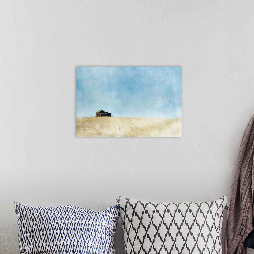 A bohemian room featuring A painterly photo of a small abandoned farmhouse in the middle of a prairie grain field.