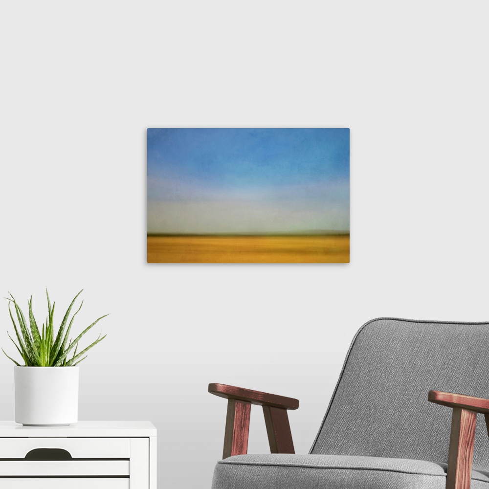 A modern room featuring Impressionist landscape of a prairie farm field and blue sky.