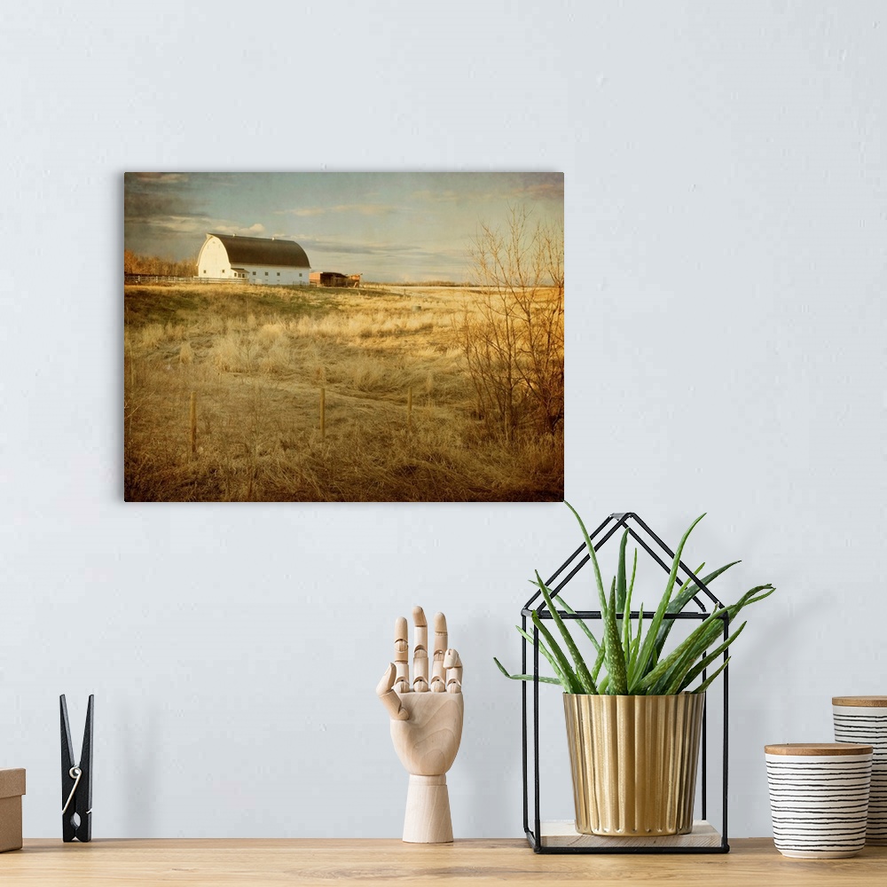 A bohemian room featuring Pictorialist photo of a traditional white farm barn on a sunny spring morning on the prairies.