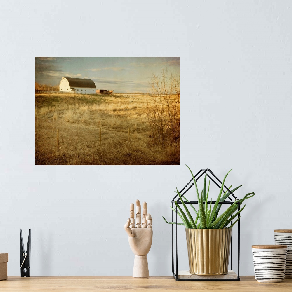 A bohemian room featuring Pictorialist photo of a traditional white farm barn on a sunny spring morning on the prairies.