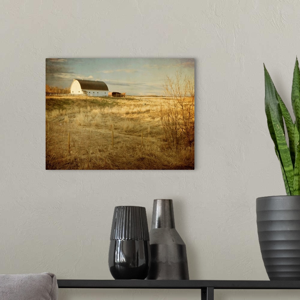 A modern room featuring Pictorialist photo of a traditional white farm barn on a sunny spring morning on the prairies.