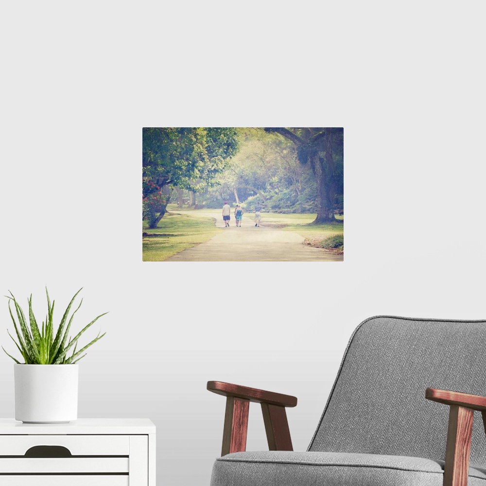 A modern room featuring Pictorialist photo of people walking along a path in the rain.