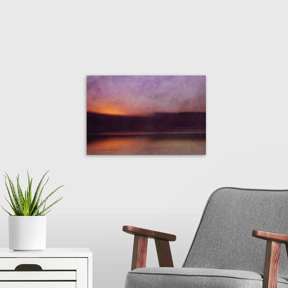 A modern room featuring Photograph of a cove surrounded by silhouetted land forms with a sunset illuminating the sky in p...