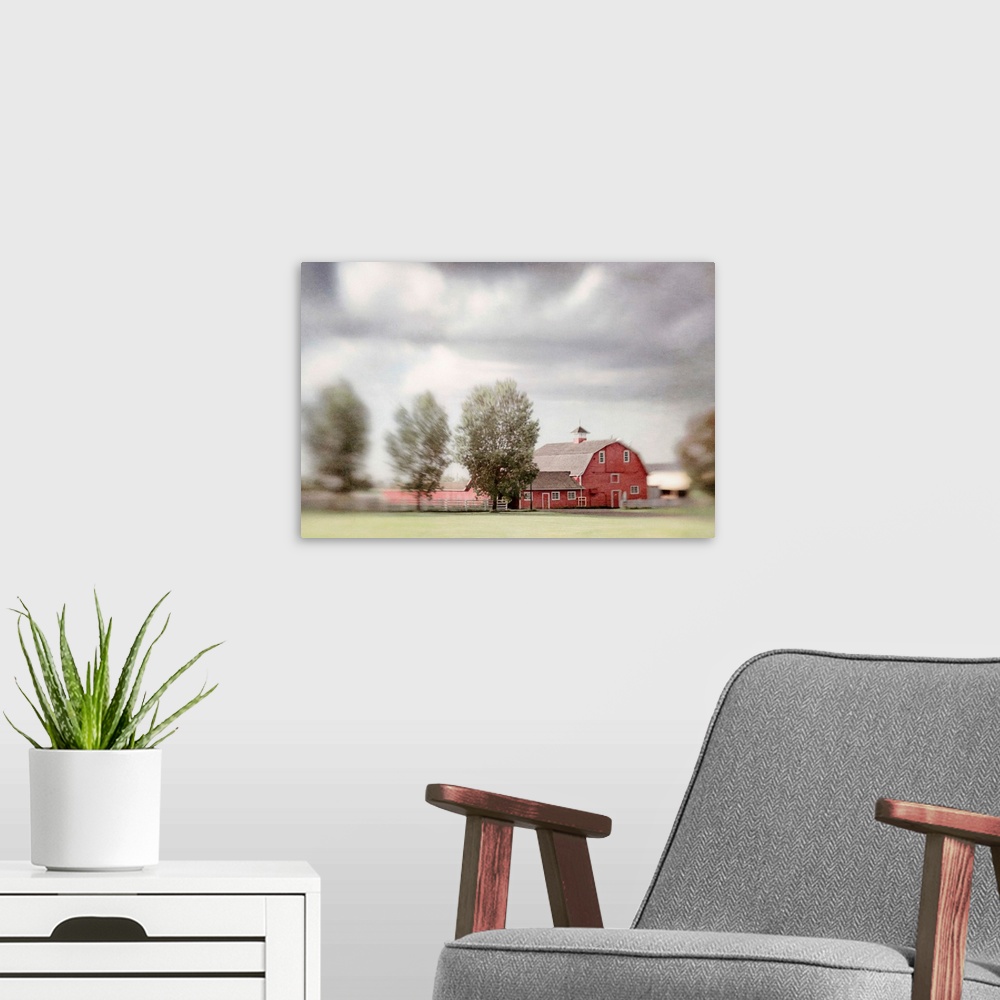 A modern room featuring Pictorialist photo of a big red horse barn on a Canadian farm.