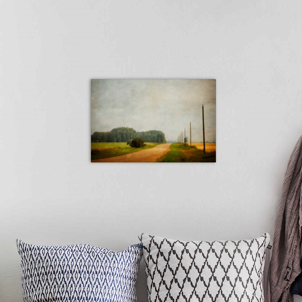 A bohemian room featuring A distressed photo of country landscape with a silo in the background.