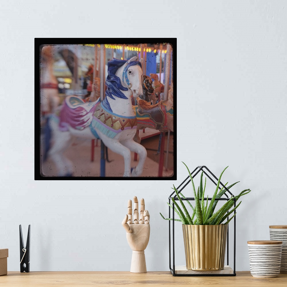 A bohemian room featuring Square image of a horse on a carousal with a blurred focus.