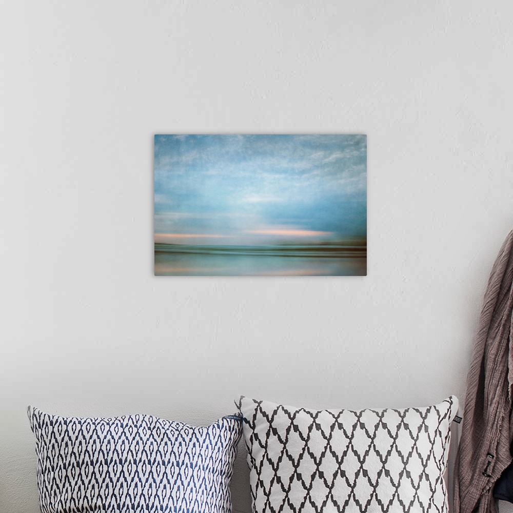 A bohemian room featuring Photograph of a seascape under a blanket of smooth crystal blue clouds.