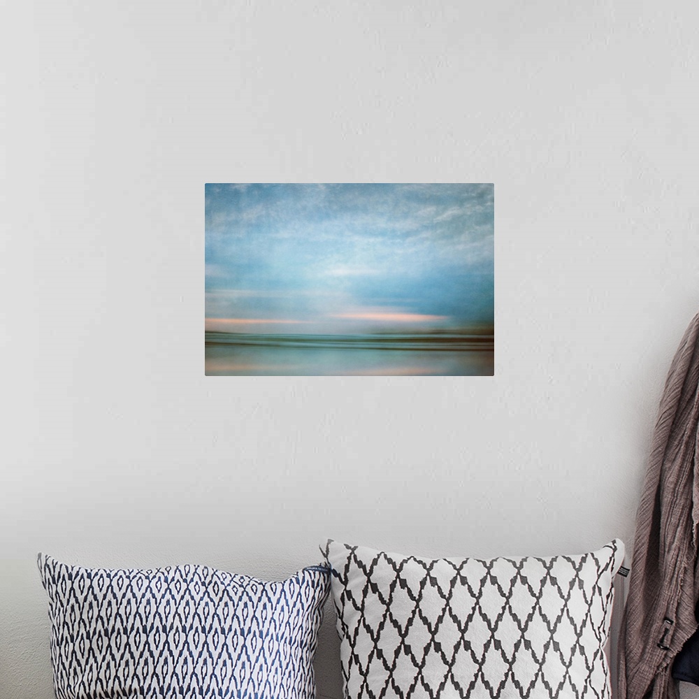 A bohemian room featuring Photograph of a seascape under a blanket of smooth crystal blue clouds.
