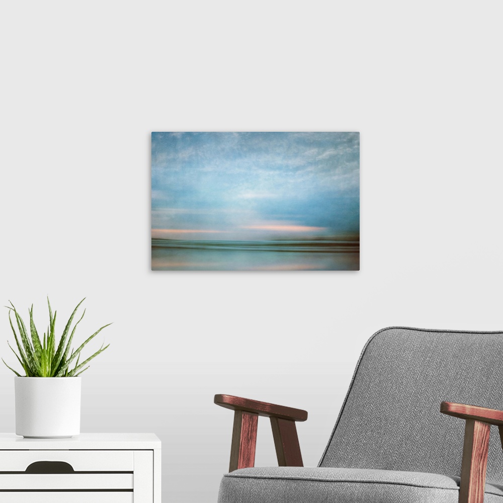 A modern room featuring Photograph of a seascape under a blanket of smooth crystal blue clouds.