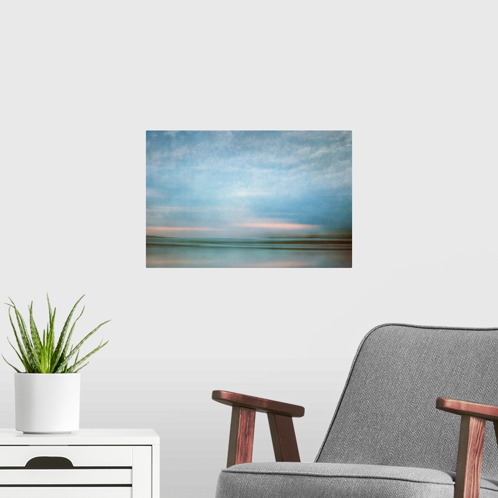 A modern room featuring Photograph of a seascape under a blanket of smooth crystal blue clouds.