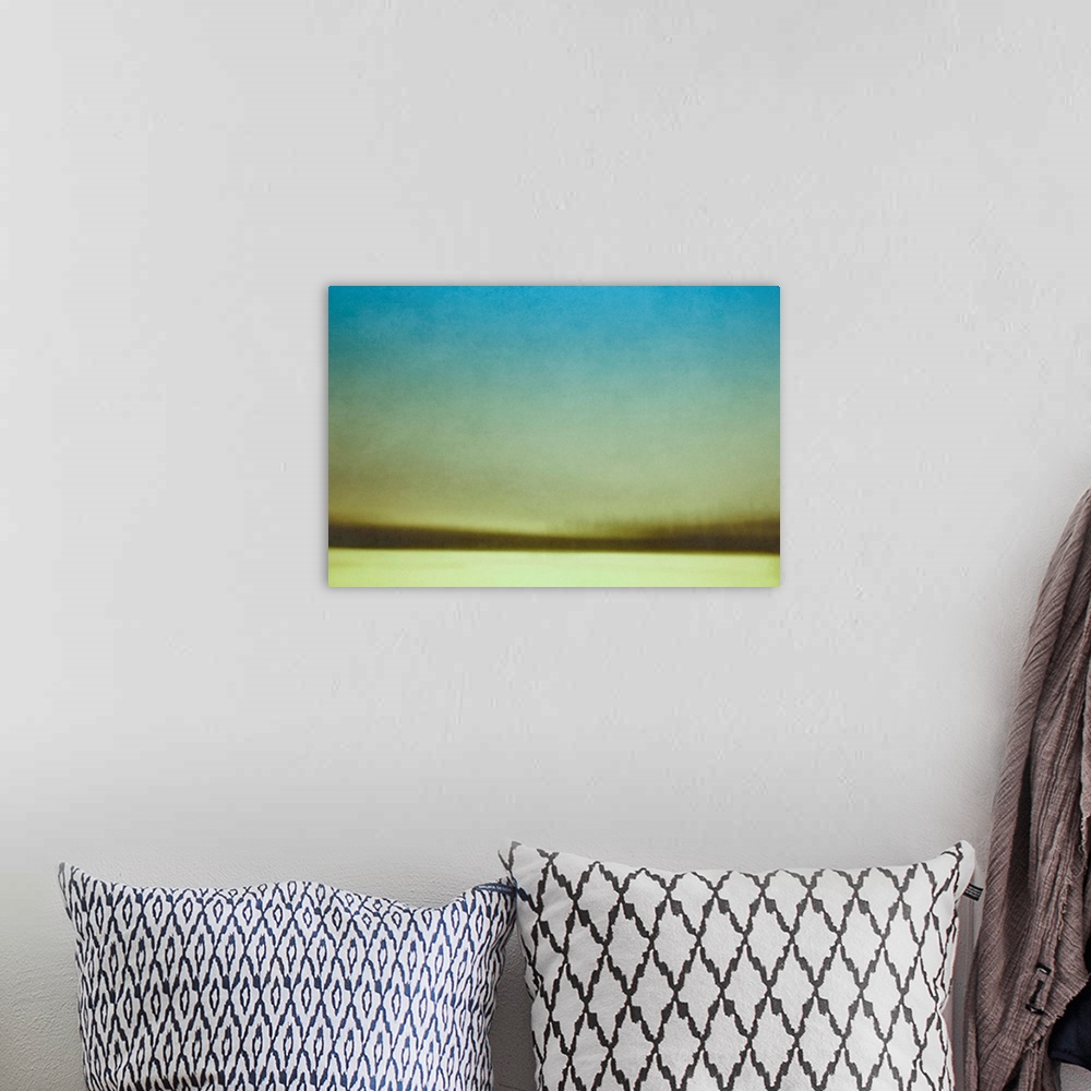 A bohemian room featuring A contemporary abstract photograph of a winter field and trees.