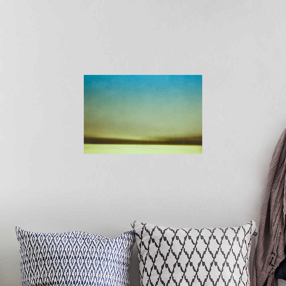 A bohemian room featuring A contemporary abstract photograph of a winter field and trees.