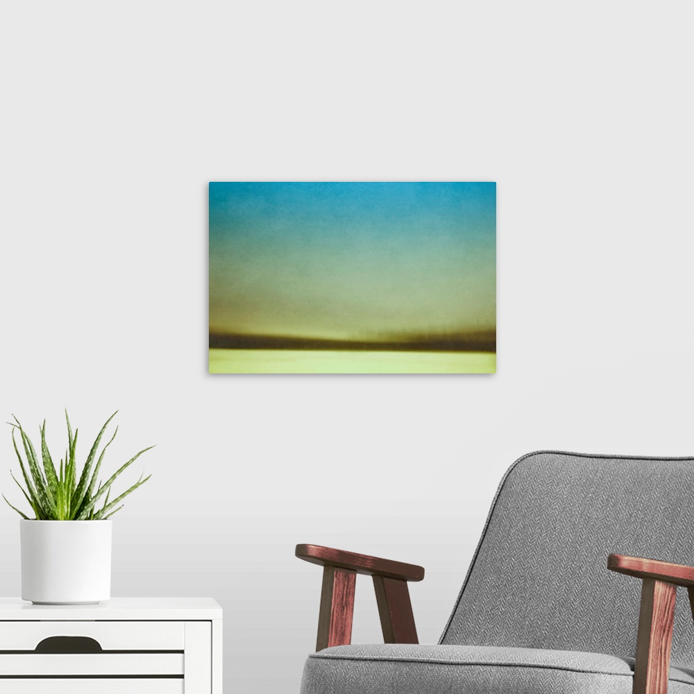 A modern room featuring A contemporary abstract photograph of a winter field and trees.