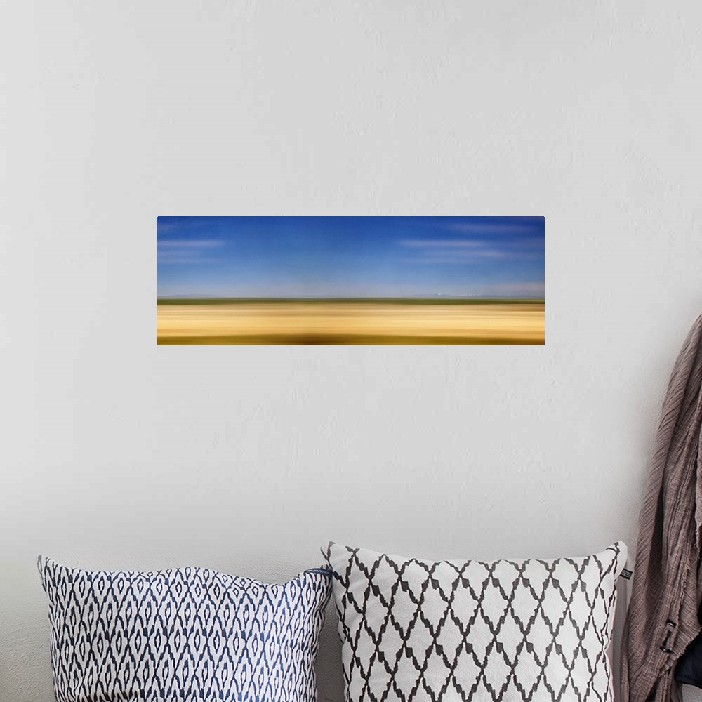 A bohemian room featuring Photograph of golden western plains looking as if they're rushing by.