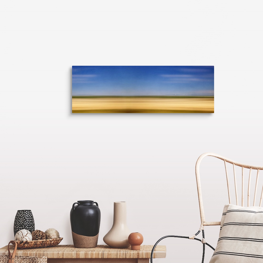 A farmhouse room featuring Photograph of golden western plains looking as if they're rushing by.