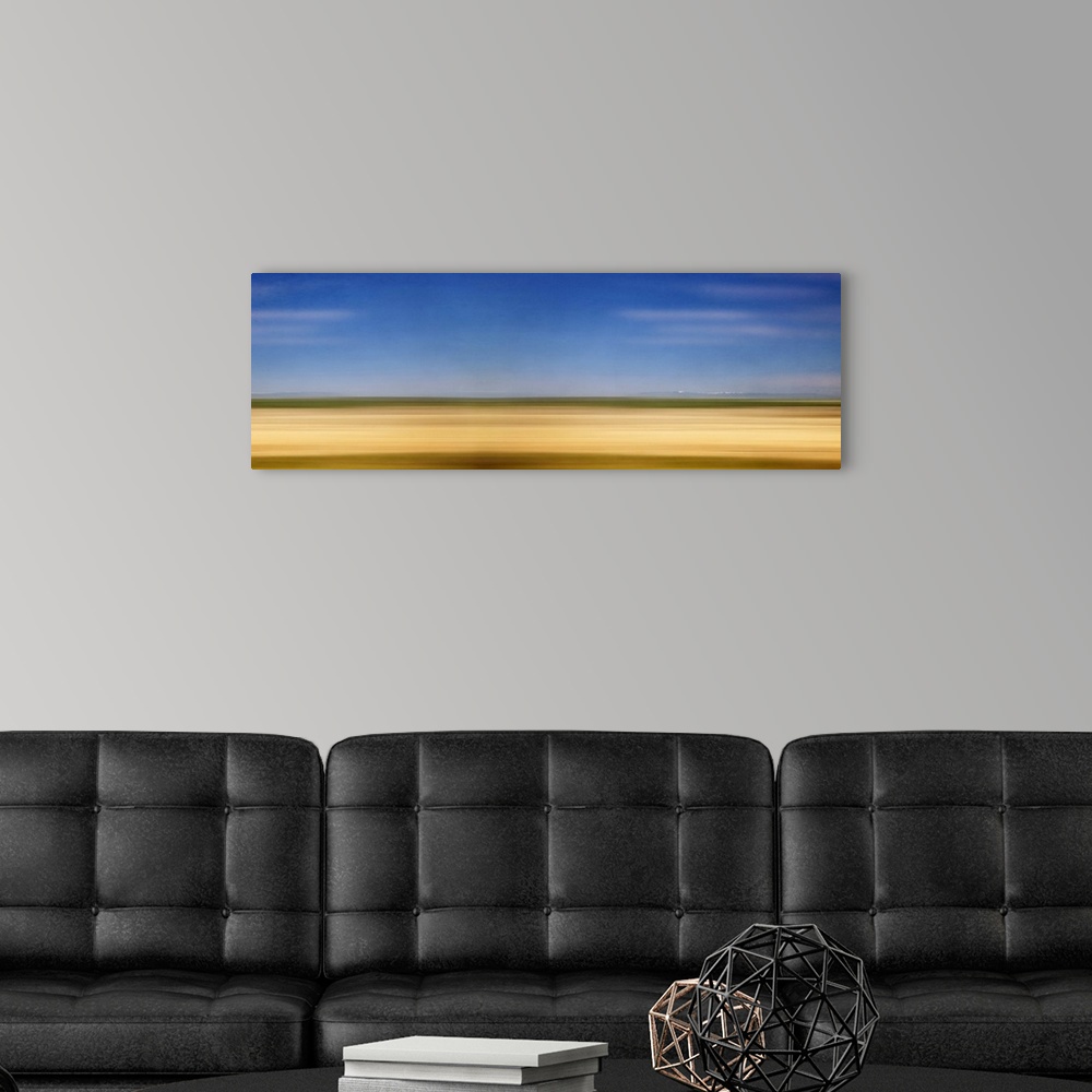 A modern room featuring Photograph of golden western plains looking as if they're rushing by.