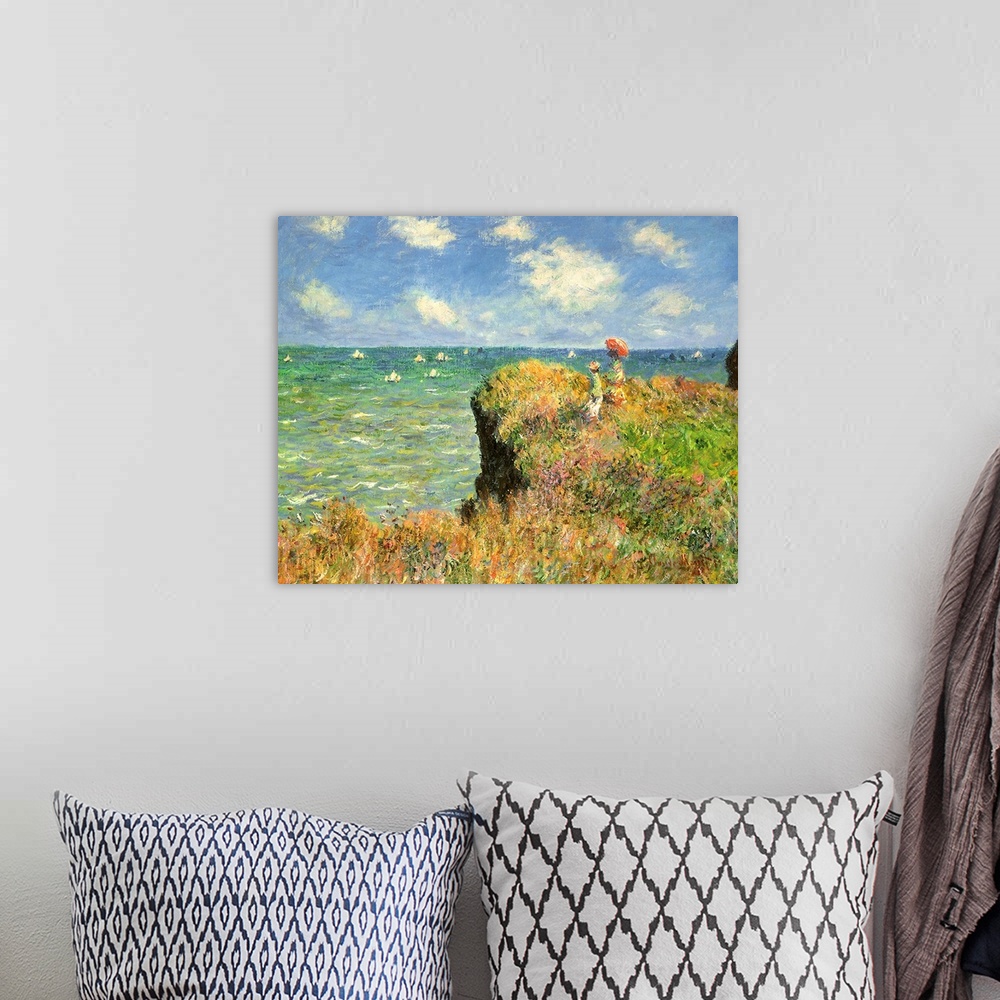 A bohemian room featuring Painting of people on grassy cliff overlooking ocean full of sailboats under a cloudy sky.