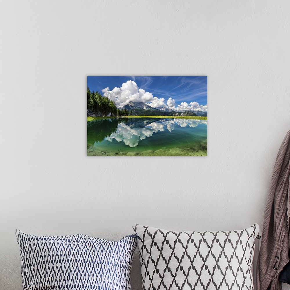 A bohemian room featuring A clear lake in Berchtesgaden, Germany, reflecting the clouds and mountains.