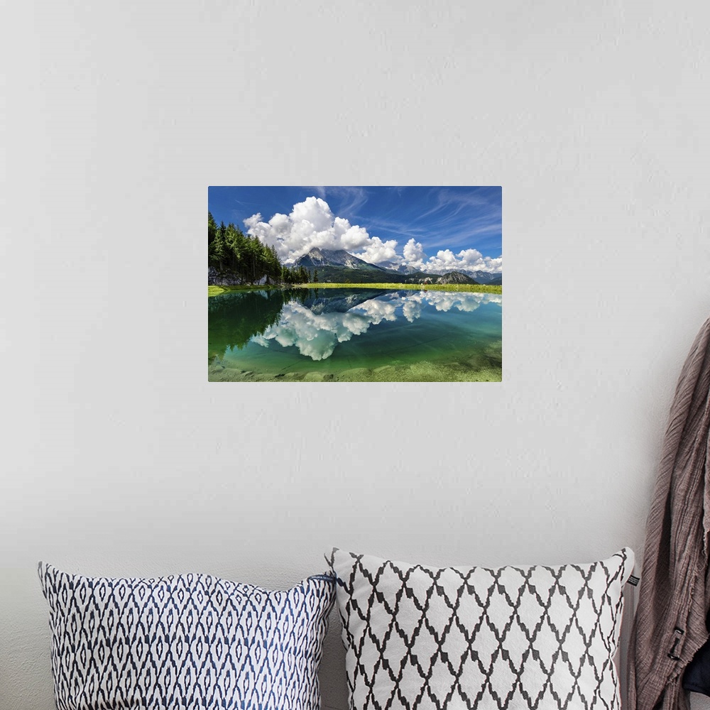 A bohemian room featuring A clear lake in Berchtesgaden, Germany, reflecting the clouds and mountains.