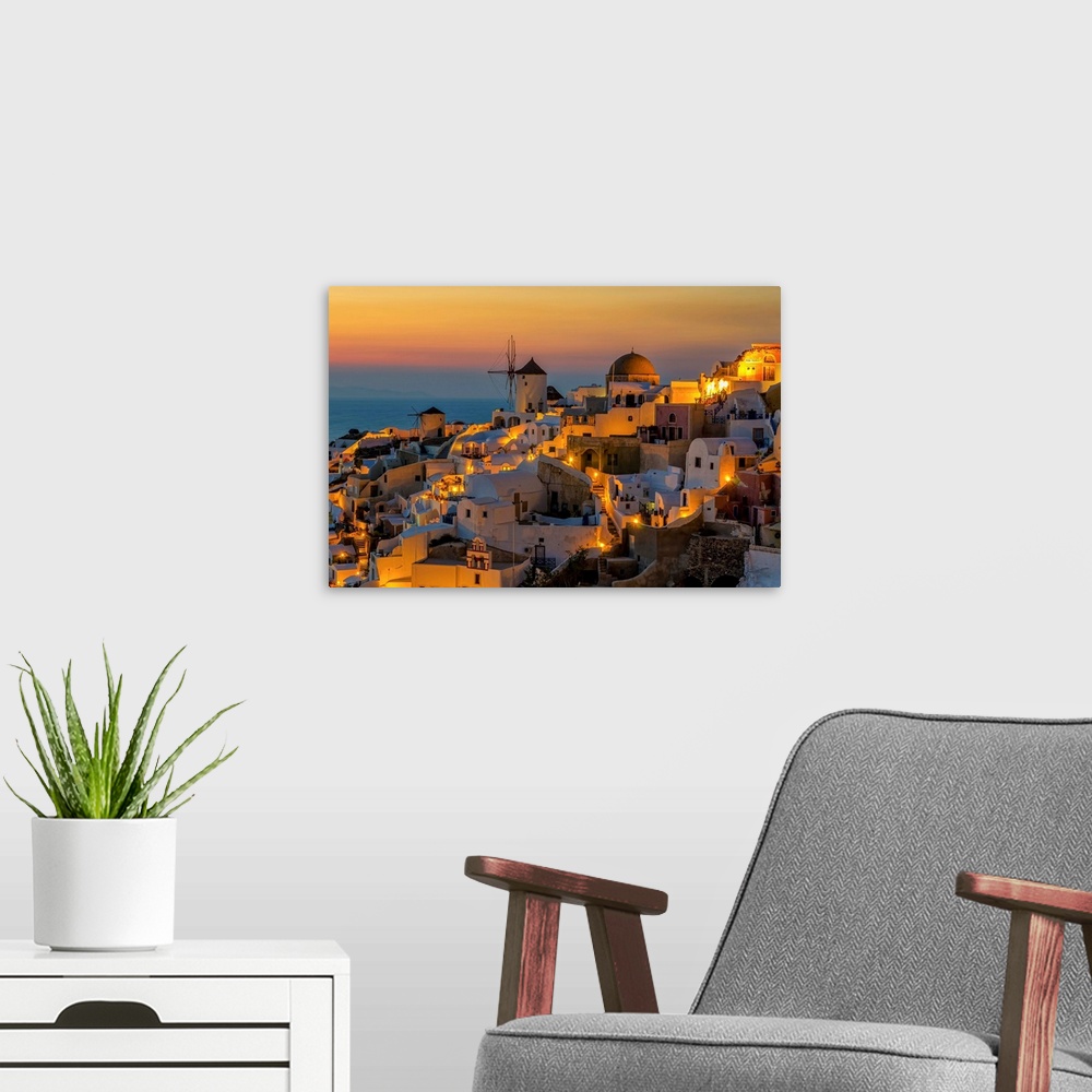 A modern room featuring Sunset moment in Oia village, Santorini island, Greece.
