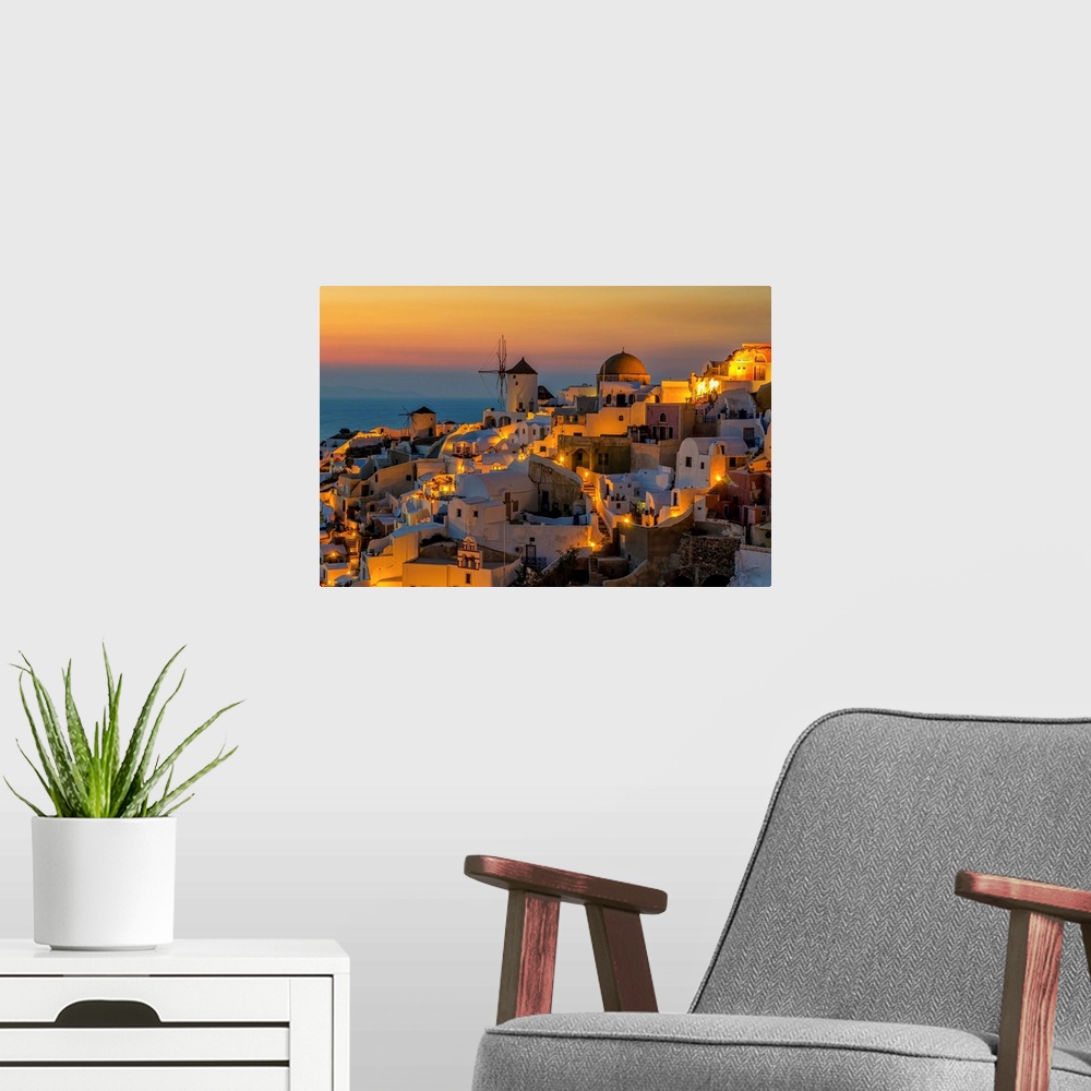 A modern room featuring Sunset moment in Oia village, Santorini island, Greece.