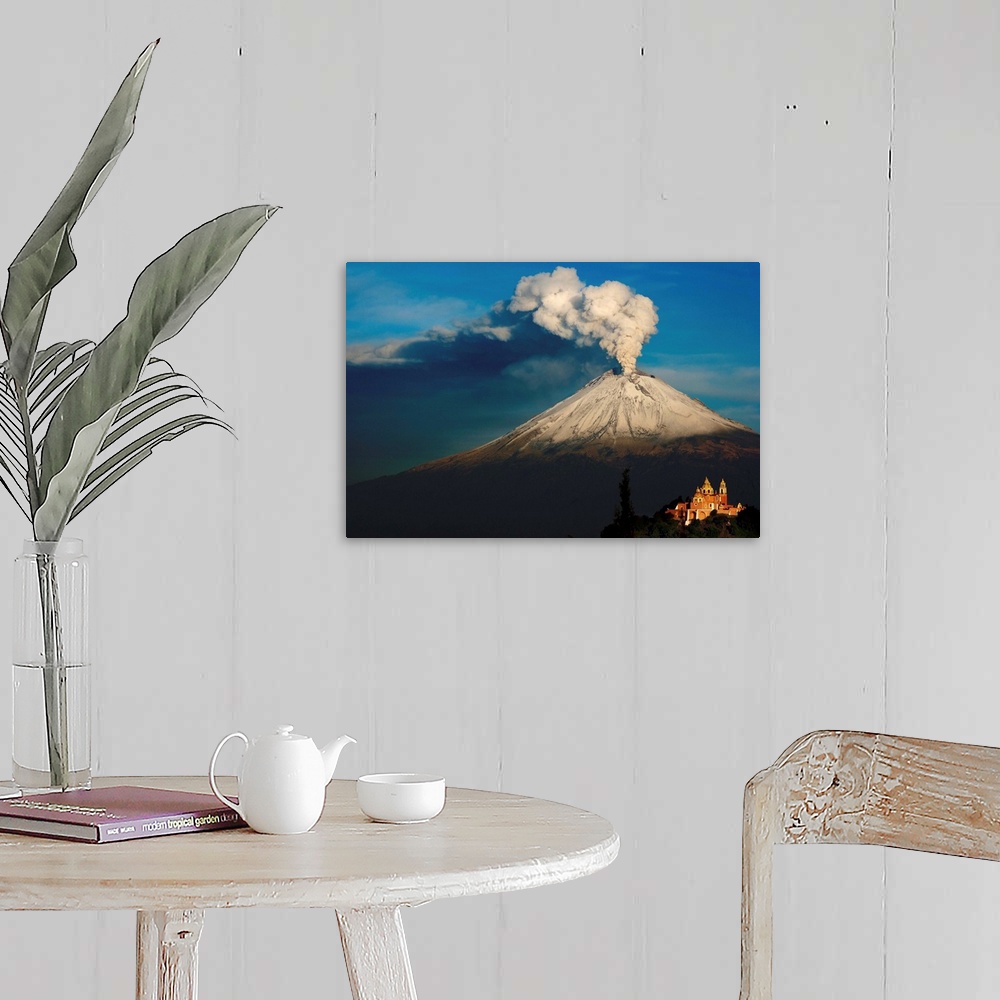 A farmhouse room featuring Clouds of ash rising from snowy  Popocatepetl volcano, Mexico.