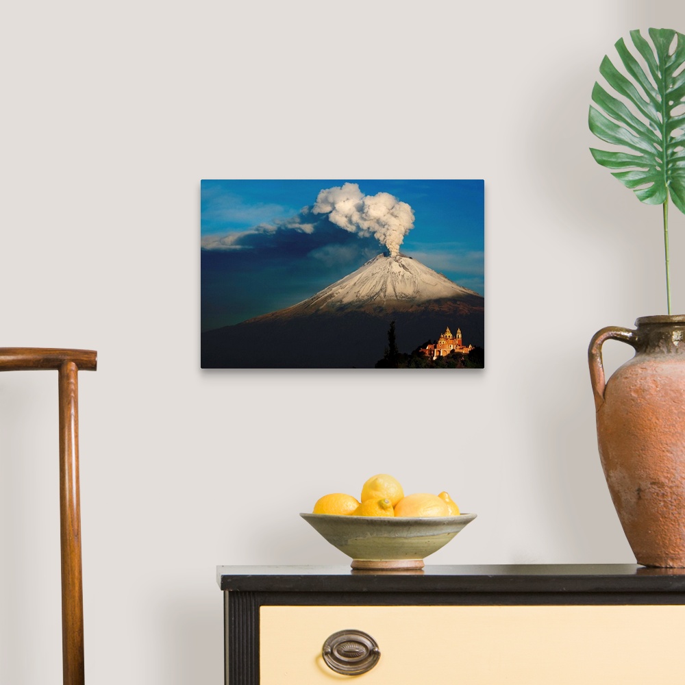 A traditional room featuring Clouds of ash rising from snowy  Popocatepetl volcano, Mexico.