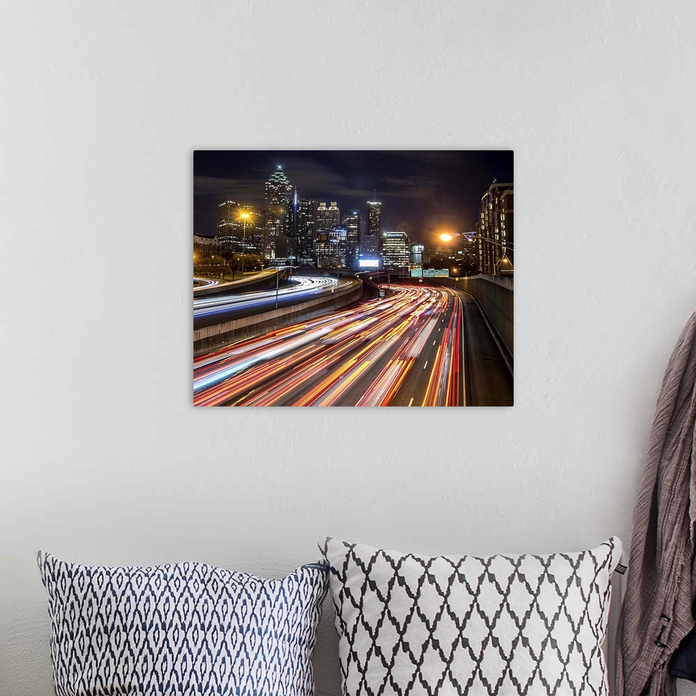 A bohemian room featuring Light trails from traffic leading into the city of Atlanta, Georgia, at night.