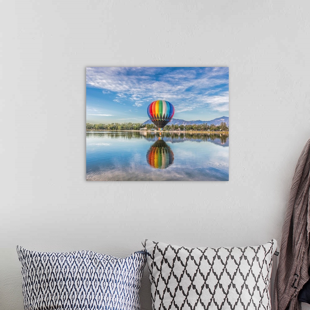 A bohemian room featuring A hot air balloon floating over a lake.
