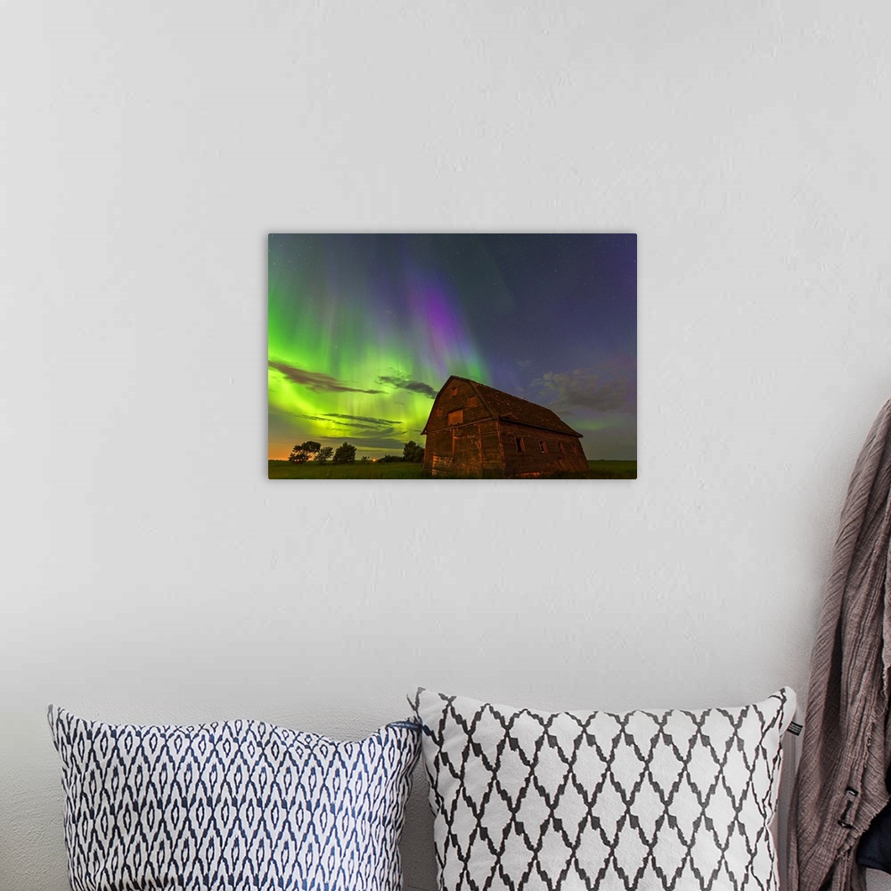 A bohemian room featuring Photograph of a barn with northern lights illuminating the sky at night.