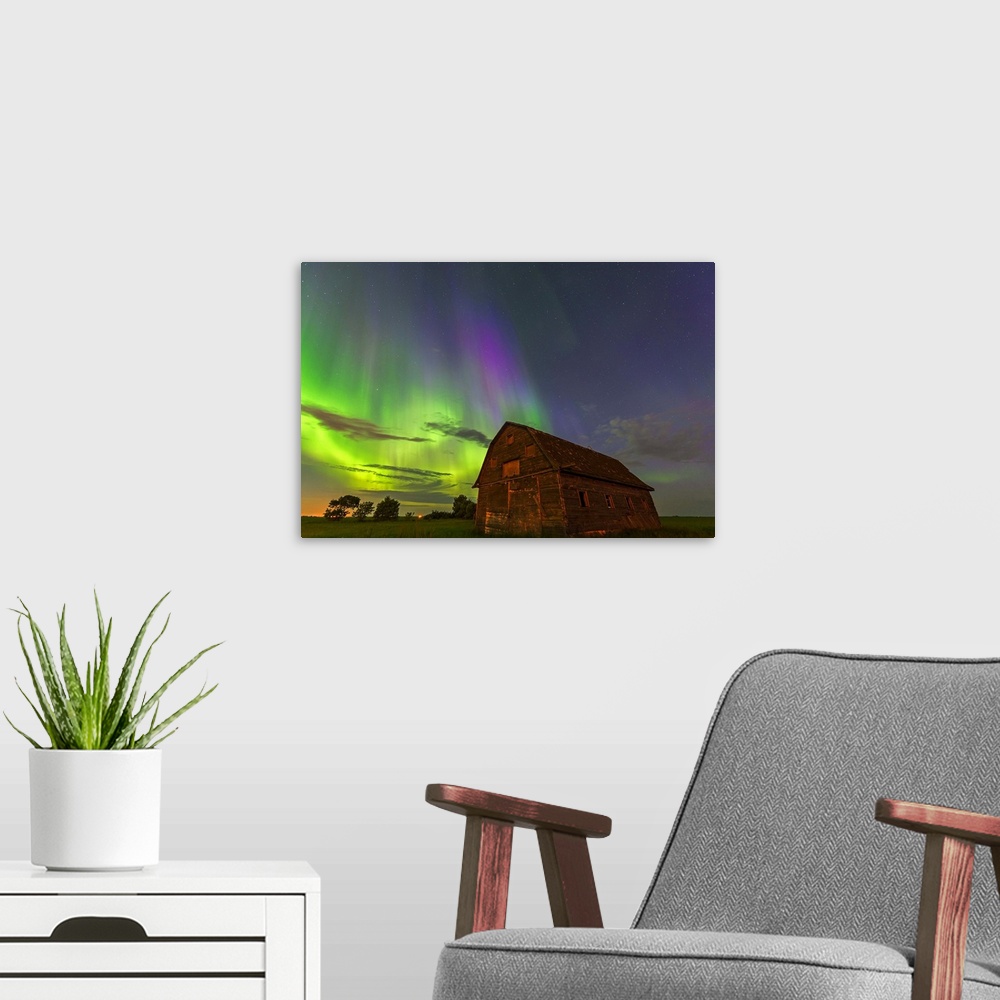 A modern room featuring Photograph of a barn with northern lights illuminating the sky at night.