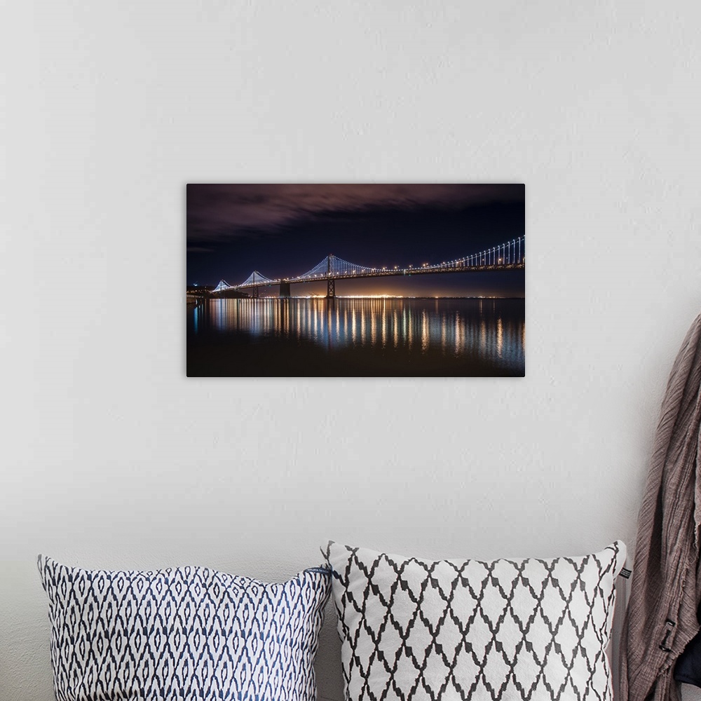 A bohemian room featuring Photograph of a long bridge lit up at night, San Francisco.