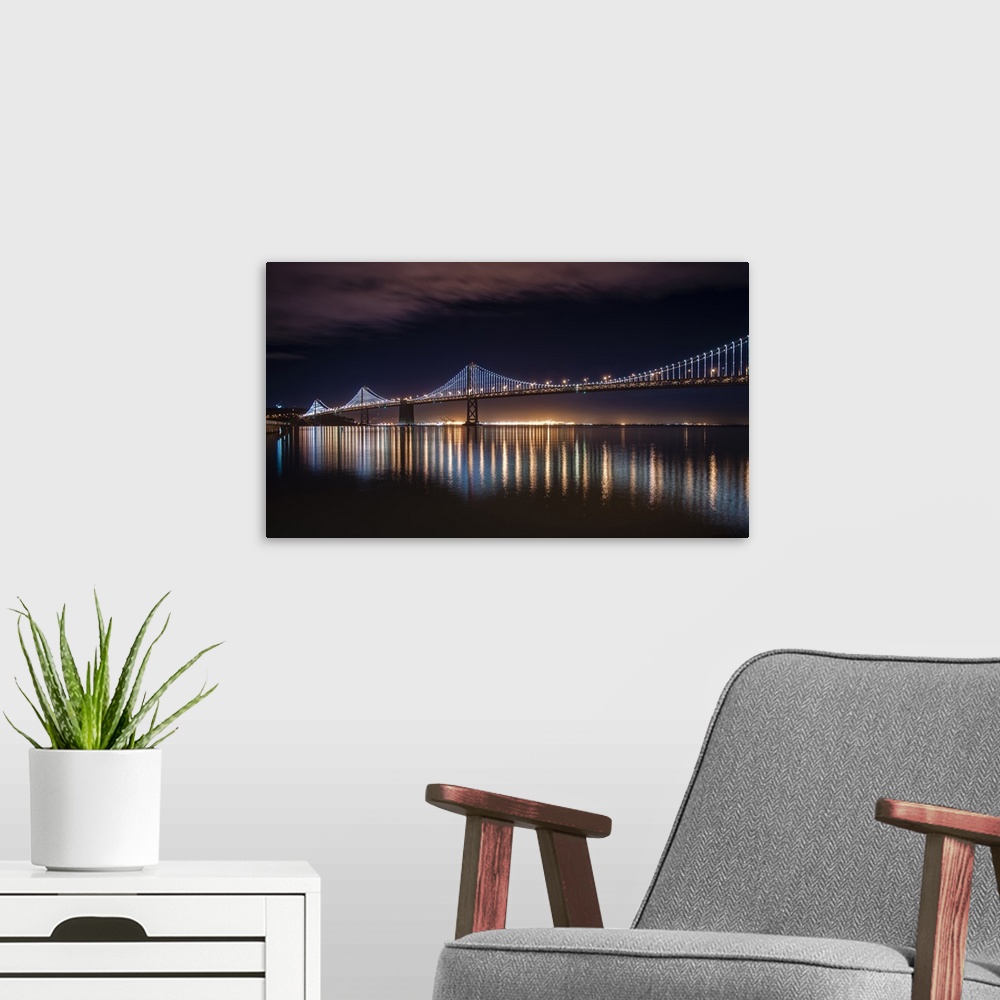 A modern room featuring Photograph of a long bridge lit up at night, San Francisco.