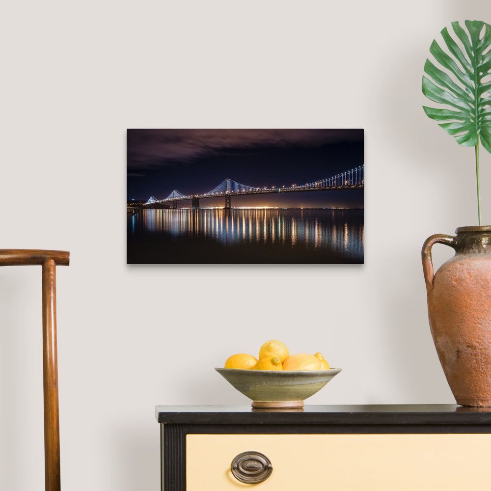 A traditional room featuring Photograph of a long bridge lit up at night, San Francisco.