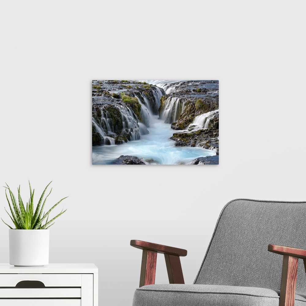 A modern room featuring Group of several waterfalls with glacial water in South Iceland.