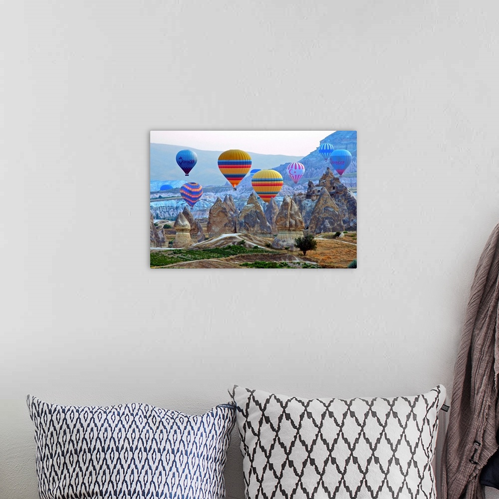 A bohemian room featuring Colorful hot air balloons over the rocky landscape of Cappadocia, Turkey.
