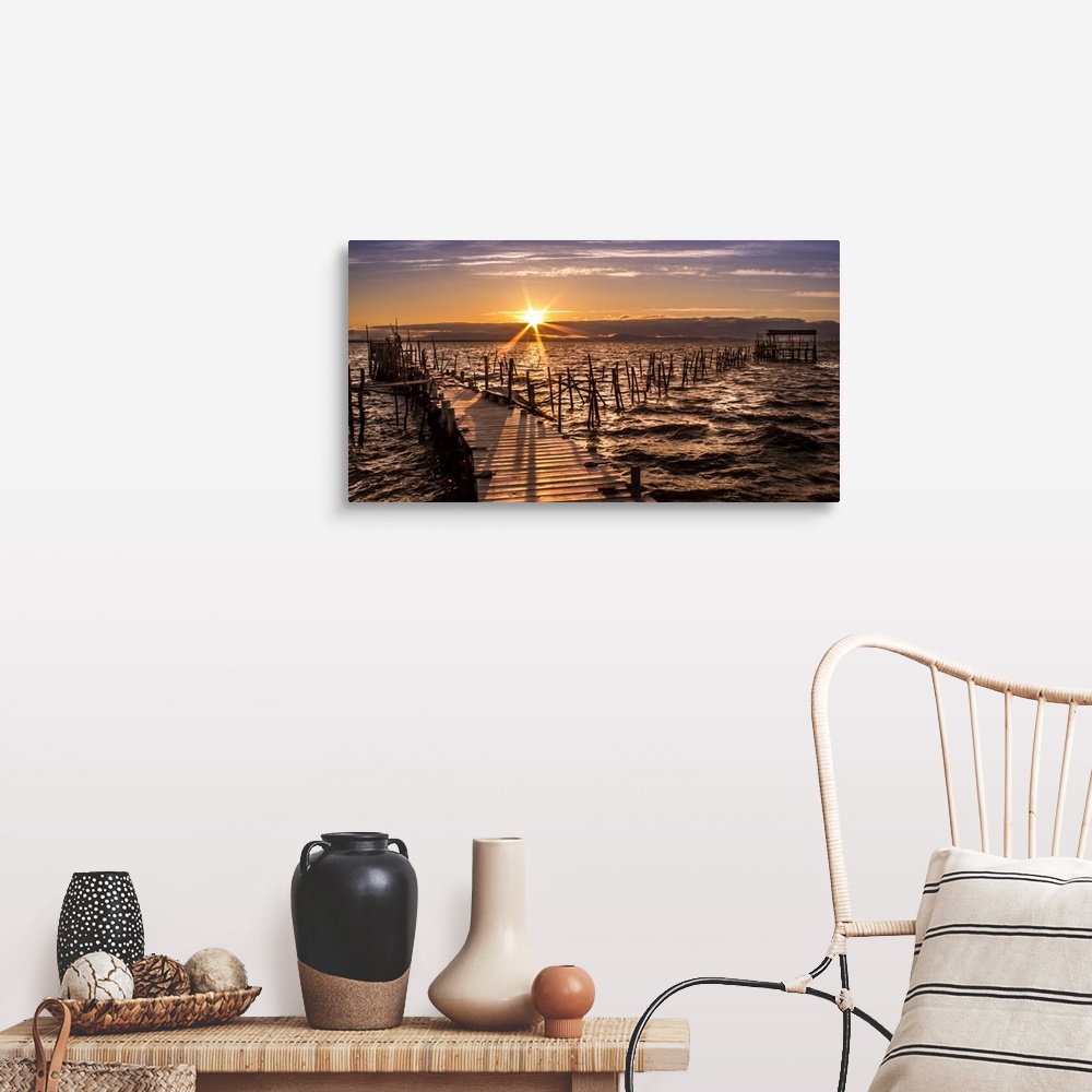 A farmhouse room featuring An old wooden pier on the coast of Portugal, at sunset.