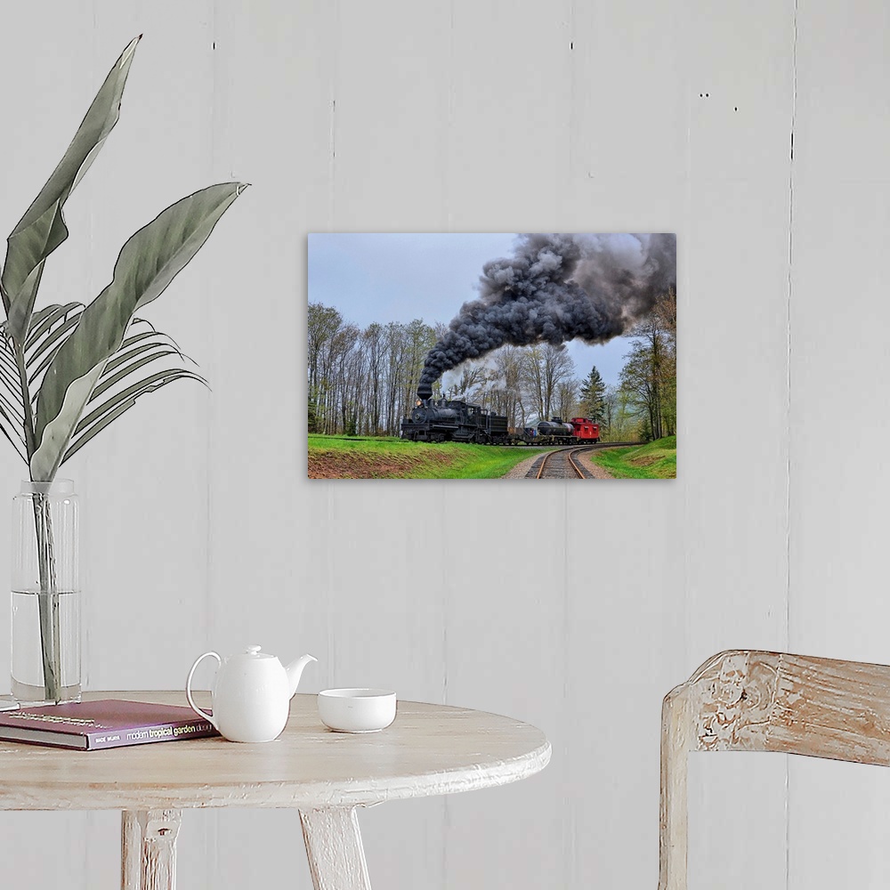 A farmhouse room featuring A locomotive with billowing black smoke climbs up a hill.